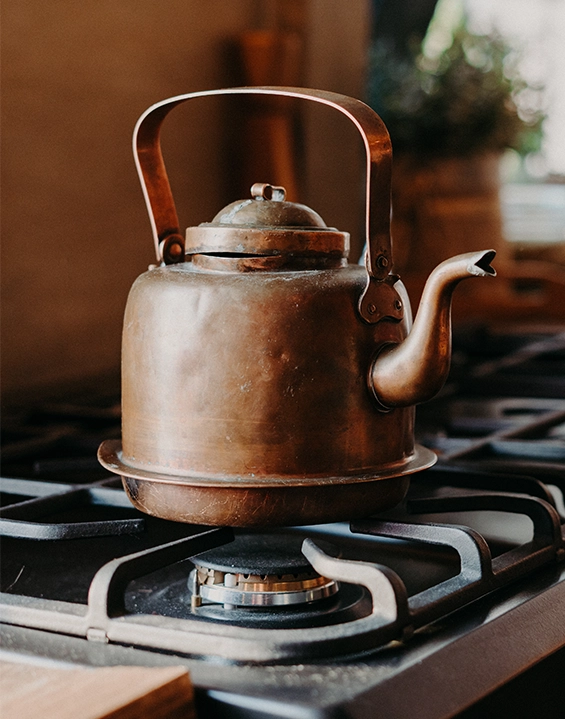 Kettle boiling on a gas appliance in a wooden home in South Africa
